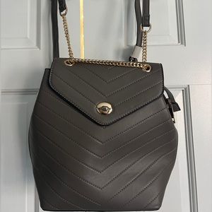 Grey backpack with gold straps